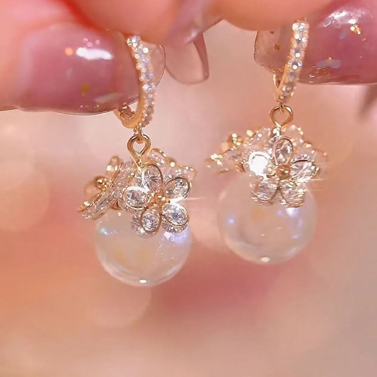 A pair of geometric-shaped zircon and rose element earrings for women, made from electroplated copper.