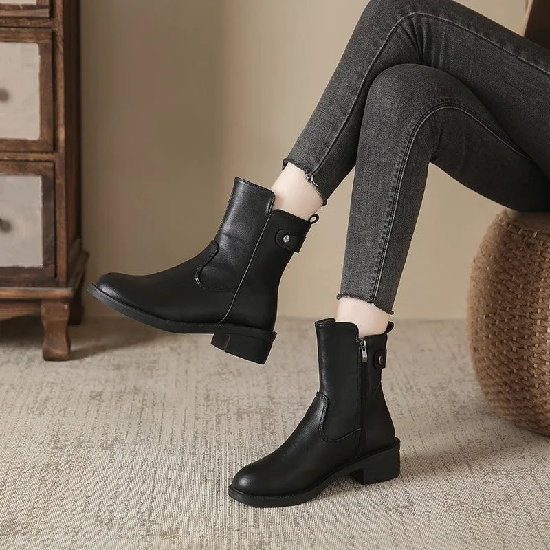 Black women's ankle boots with side zip, round toe, and a low rubber sole.