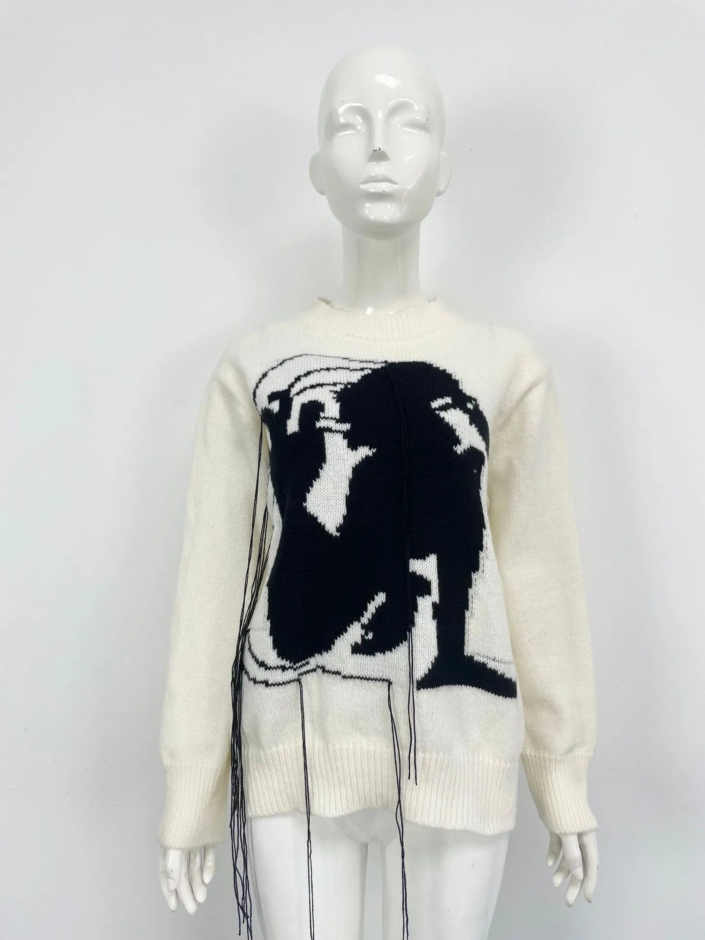 Grey women's alpaca wool pullover sweater with abstract pattern and tassel detail, loose street fashion fit.