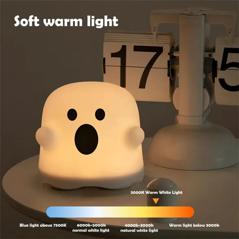 White silicone touch sensor LED night light on a bedside table.