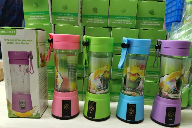 Pink portable USB blender with a transparent 380ml cup on a table, alongside a USB charging cable.