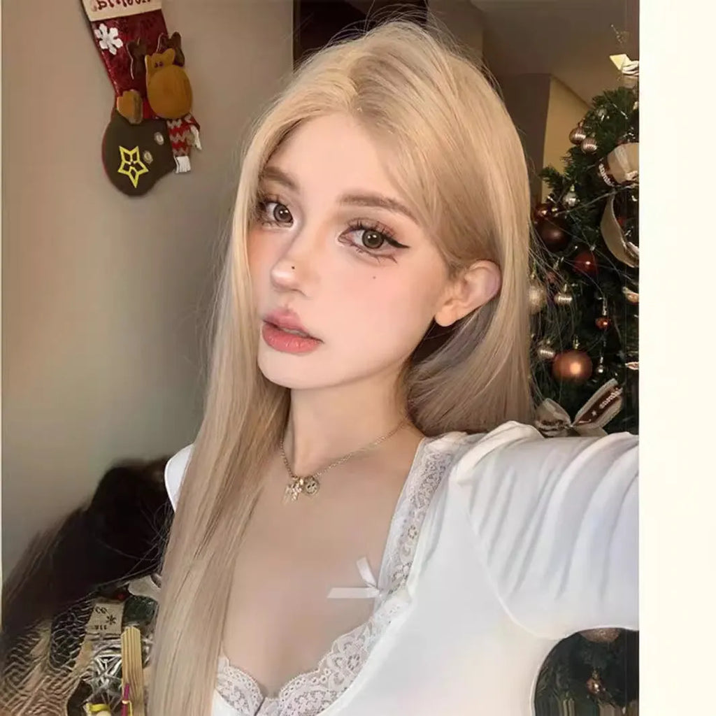 Long straight milk tea blonde synthetic wig on a model, shown with an included hair net.
