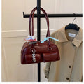 Retro pillow-shaped women's handbag in PU leather, shown in black with a flap closure and double shoulder straps.