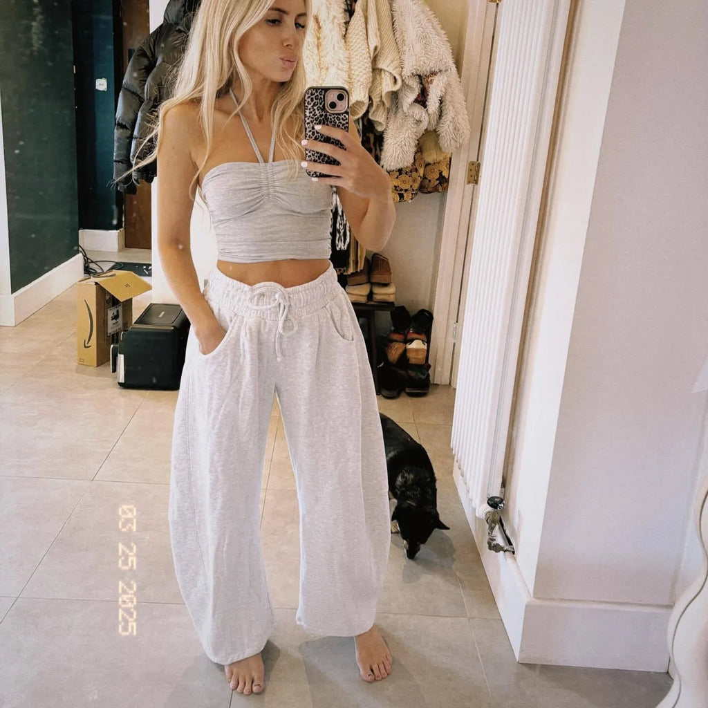 Loose sports cropped sweatpants in hot light grey with elastic waist and drawstring, showing collage/stitching craft details