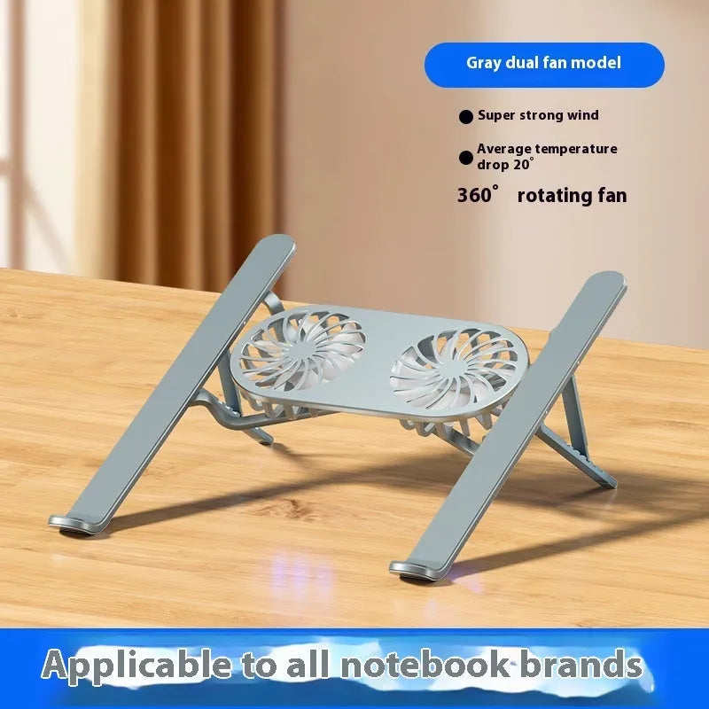 Silver aluminium laptop stand with twin cooling fans in folded position beside laptop
