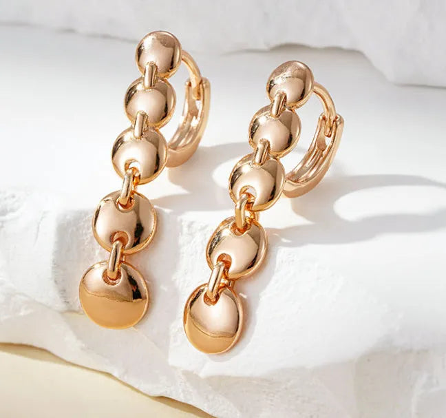 Gold-plated copper circle earrings with hand-woven texture, measuring 6cm in length