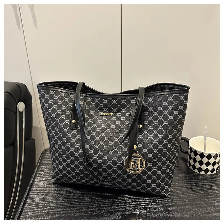 PU street style shoulder bag in black showing 42cm width and sewing thread detailing with polyester lining