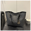 PU street style shoulder bag in black showing 42cm width and sewing thread detailing with polyester lining