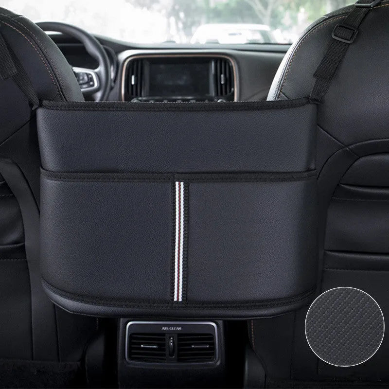 Black leather car seat storage bag with carbon fibre pattern, 38cm long, placed in middle of car seat