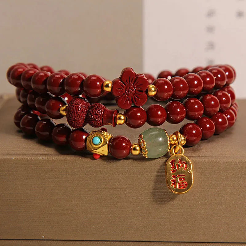 Red cinnabar bracelet with geometric gourd and flower design, 6mm diameter with clasp fastening