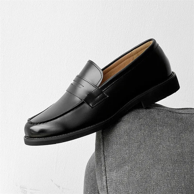 Black men's leather slip-on derby shoes on a white background