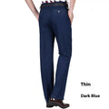 Men's high-waist loose blue denim trousers on a neutral background