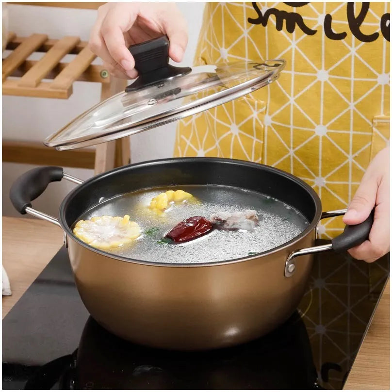 Cast iron three-piece cookware set with soup pot, milk pot, and wok on a kitchen counter