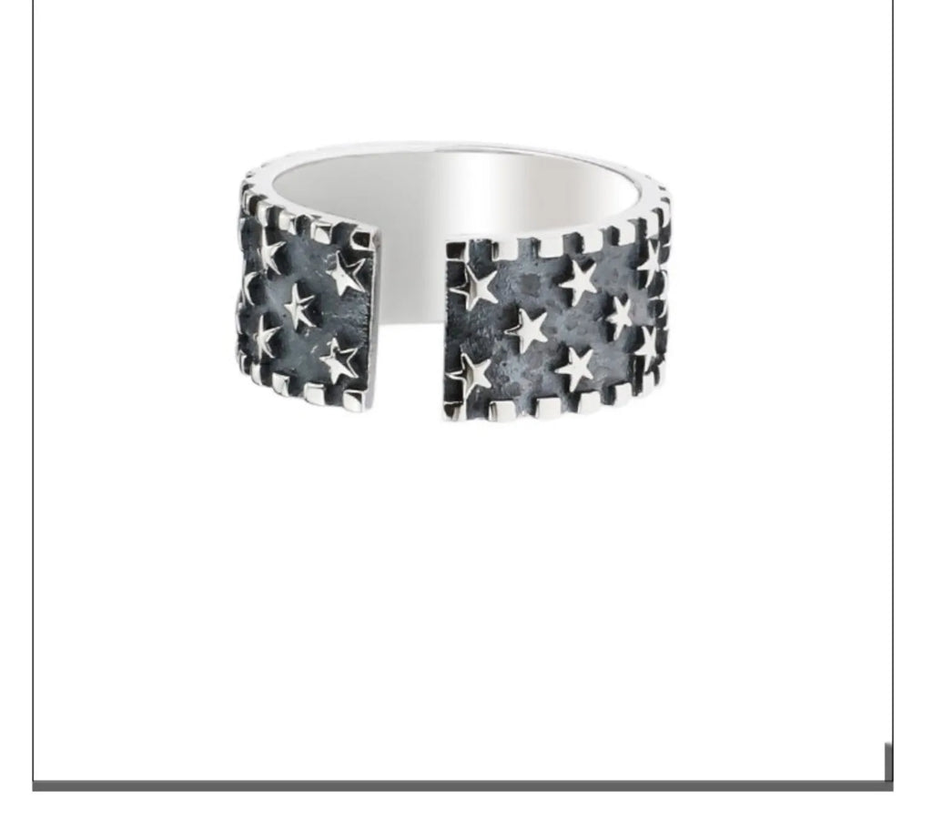 Adjustable sterling silver ring with engraved five-pointed star geometry patterns on a hand