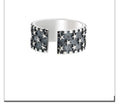 Adjustable sterling silver ring with engraved five-pointed star geometry patterns on a hand