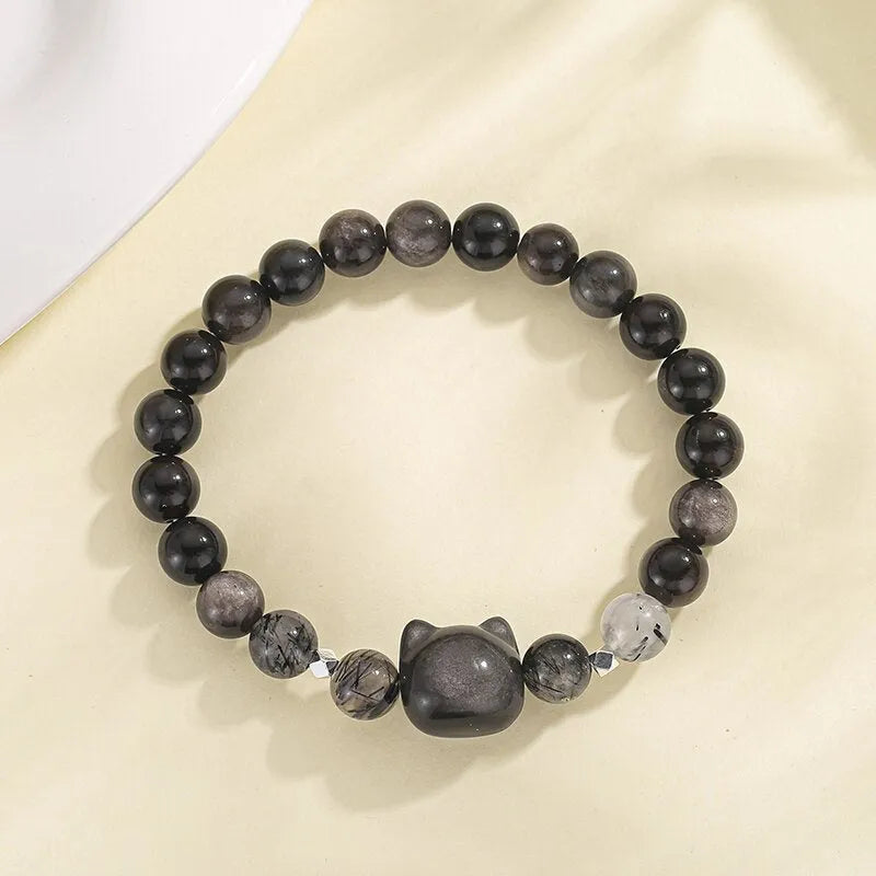 Adjustable obsidian cat bracelet with electroplated silver finish and detailed animal modelling