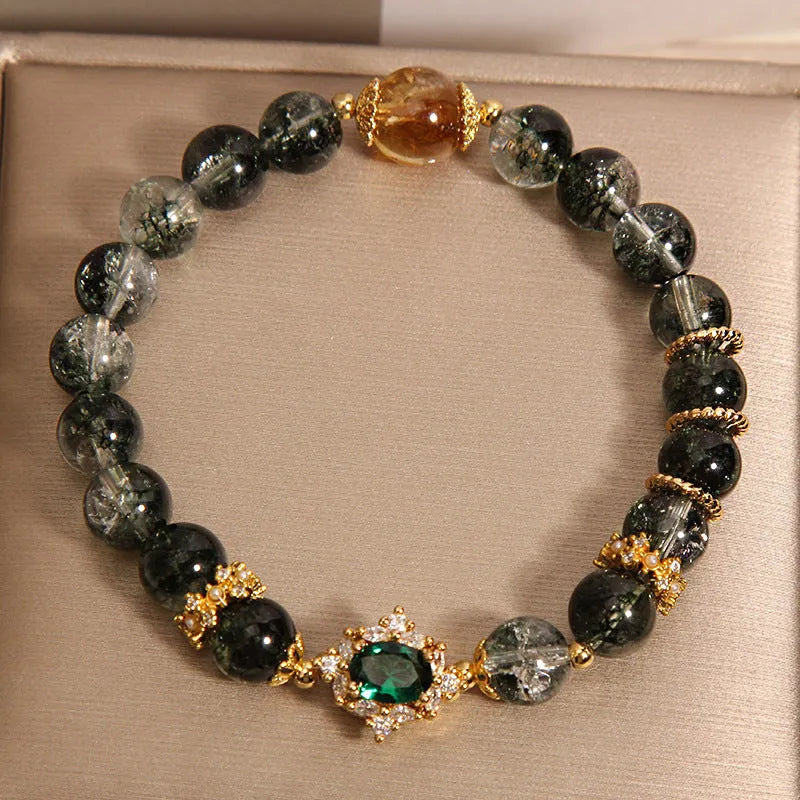 Women's gold rutilated quartz crystal bracelet with green phantom quartz beads and pearl rhinestone accents