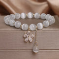 White cat's eye crystal women's bracelet with morganite safety buckle pendant and small flower tassel
