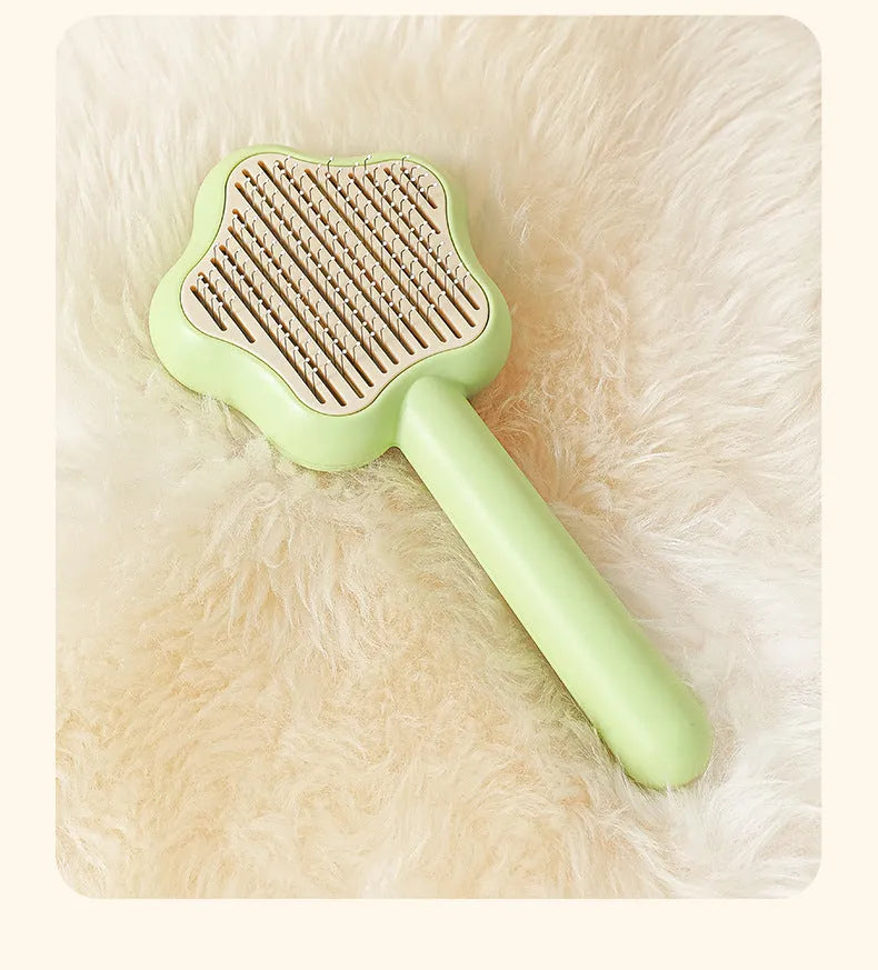 Green cat grooming comb with stainless steel needles and self-cleaning feature, 20cm length