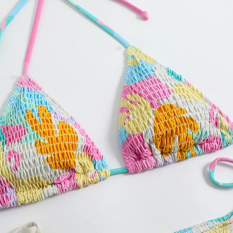 Women's multicolour floral triangle bikini with smocking detail on the top and briefs bottom.