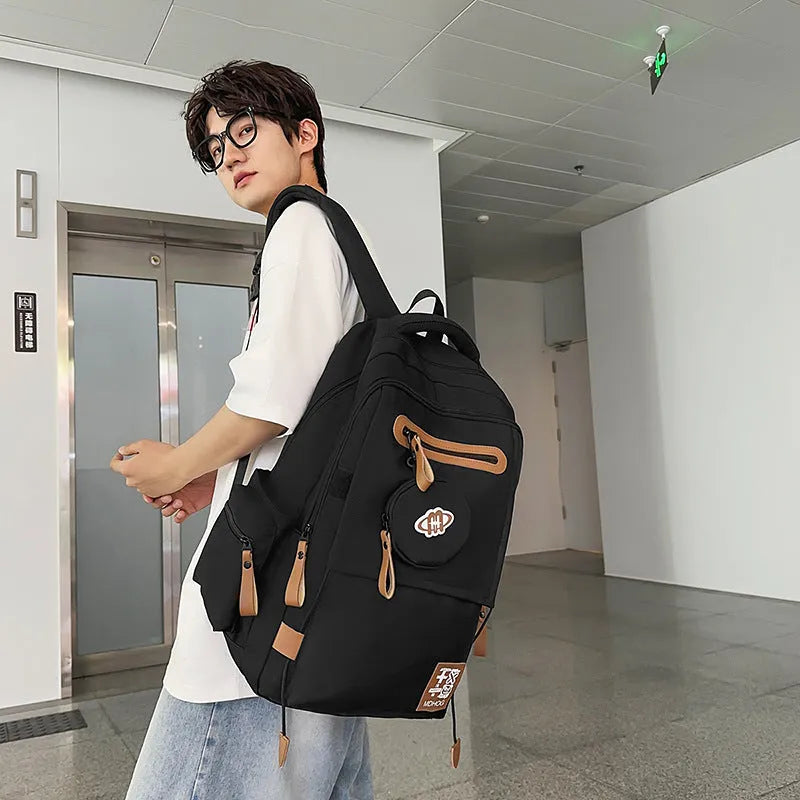 Large waterproof travel backpack in black with contrast colour stitching showing 20-35 litre capacity