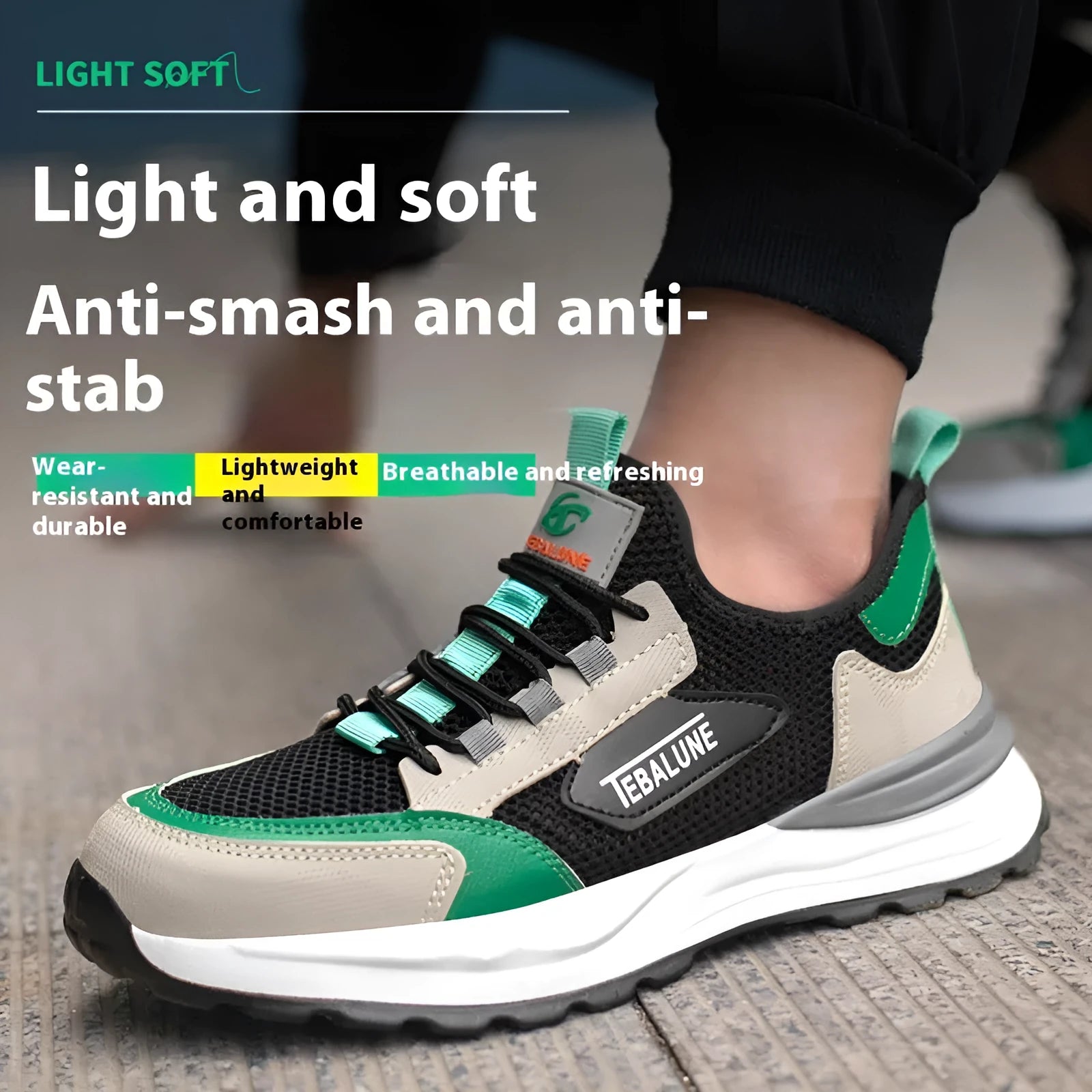 Black and green low-top safety shoes with mesh panels and a steel toe cap on a white background.