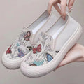 Women's black and white canvas slip-on shoes with round toe and decorative sewing thread details