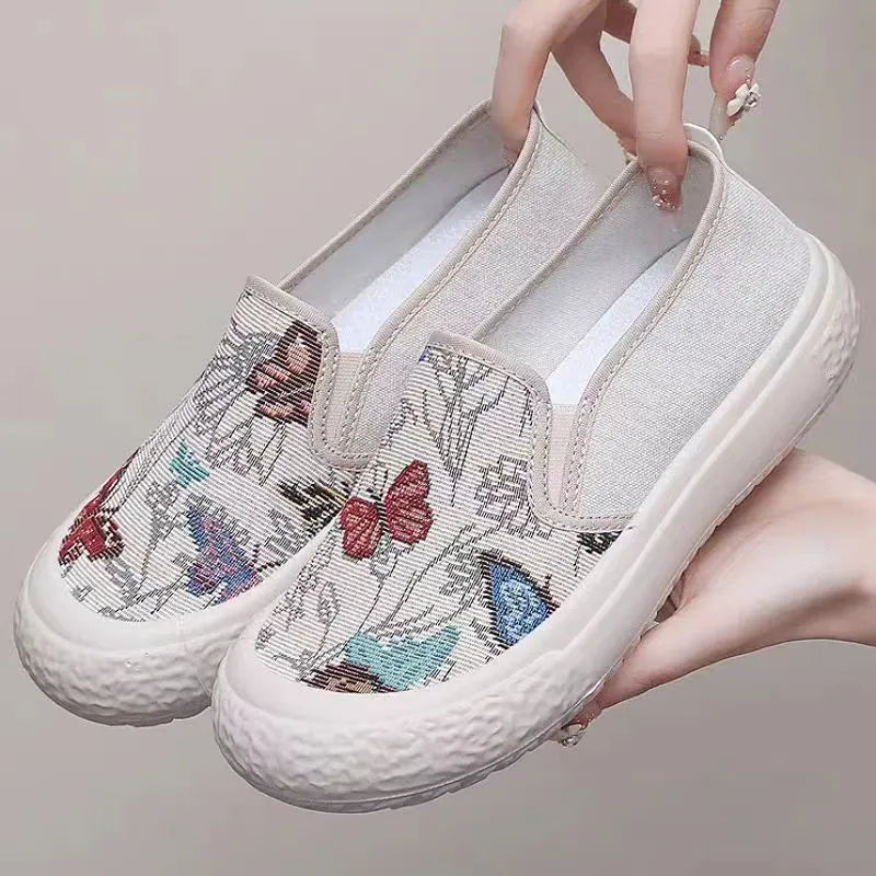 Women's black and white canvas slip-on shoes with round toe and decorative sewing thread details