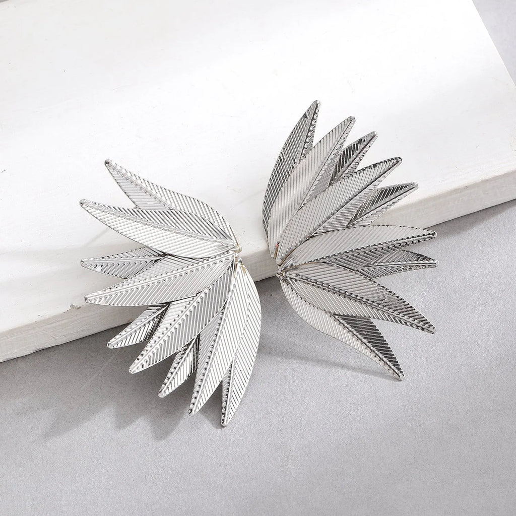 Gold and white alloy leaf-shaped stud earrings with botanical design