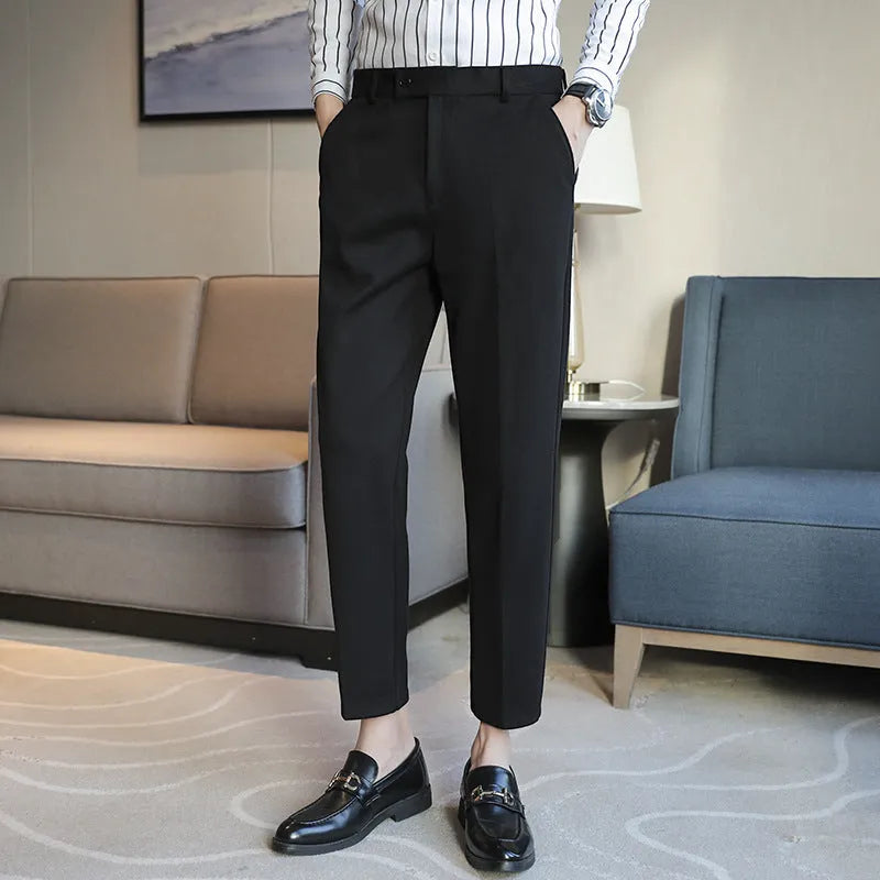 Straight leg brown corduroy trousers with an elasticated waistband on a hanger.