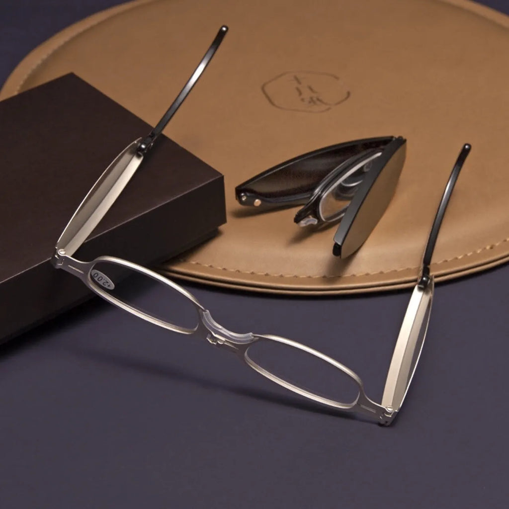 Folding pocket presbyopic glasses in retro style with ring elements, shown both open and folded to 12cm length