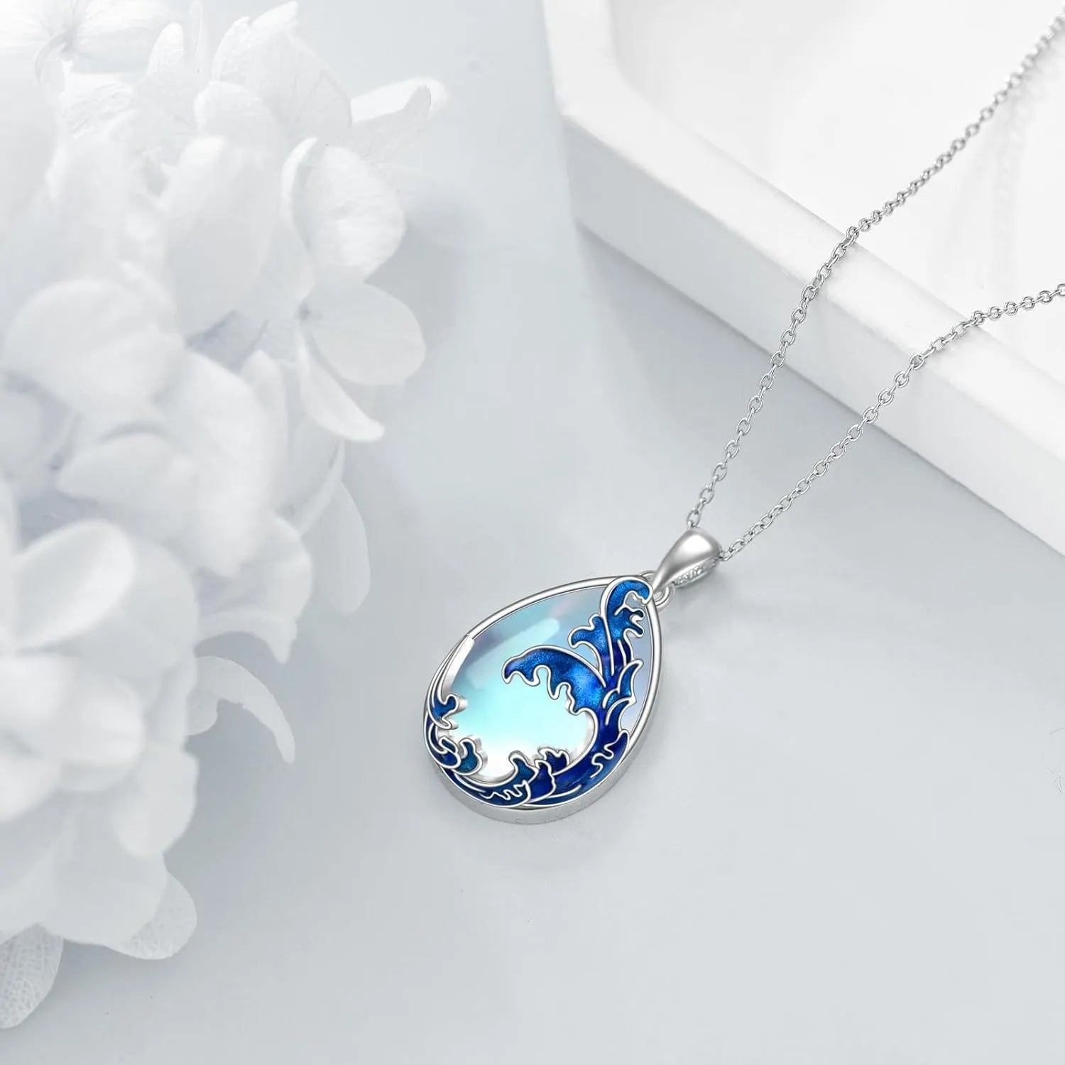 Blue heart-shaped alloy pendant on a necklace chain, love-themed women's jewellery.