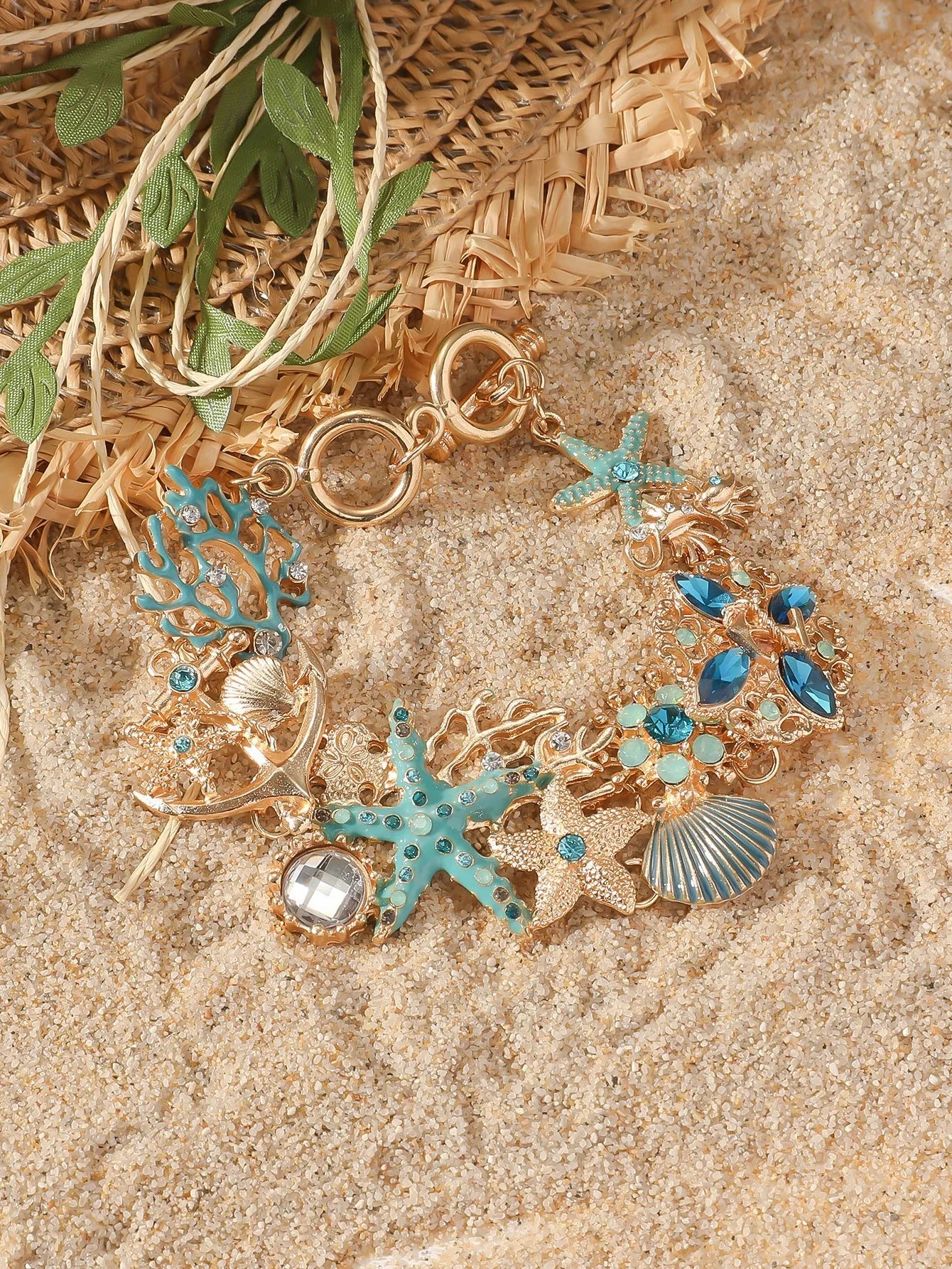 Women's alloy bracelet with starfish design in turquoise, coral red, or coral blue with marine shell and boat anchor elements