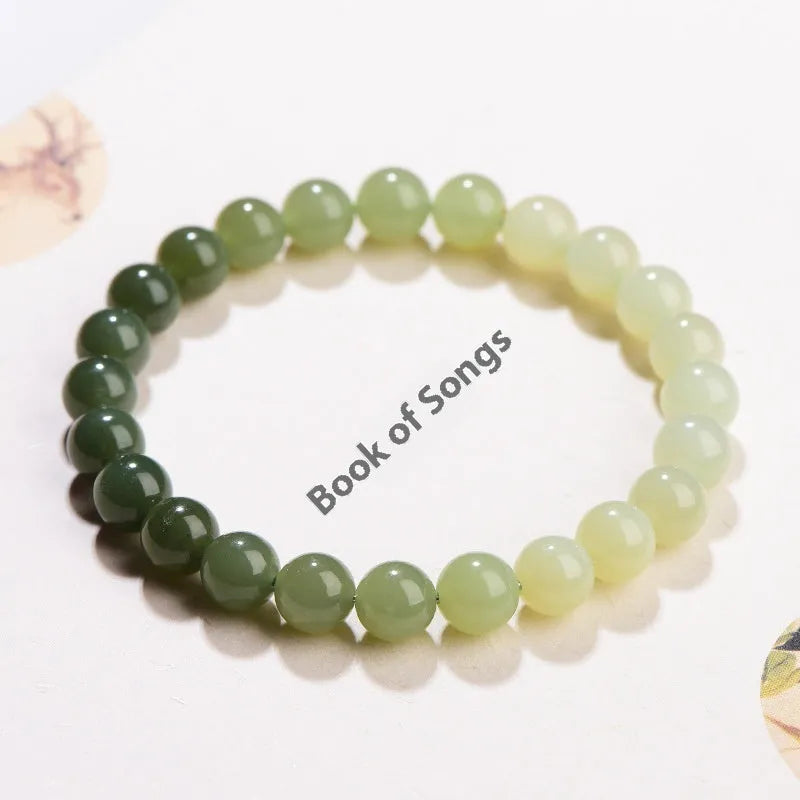 Natural gradient water Hetian jade bracelet with choice of round or barrel beads.