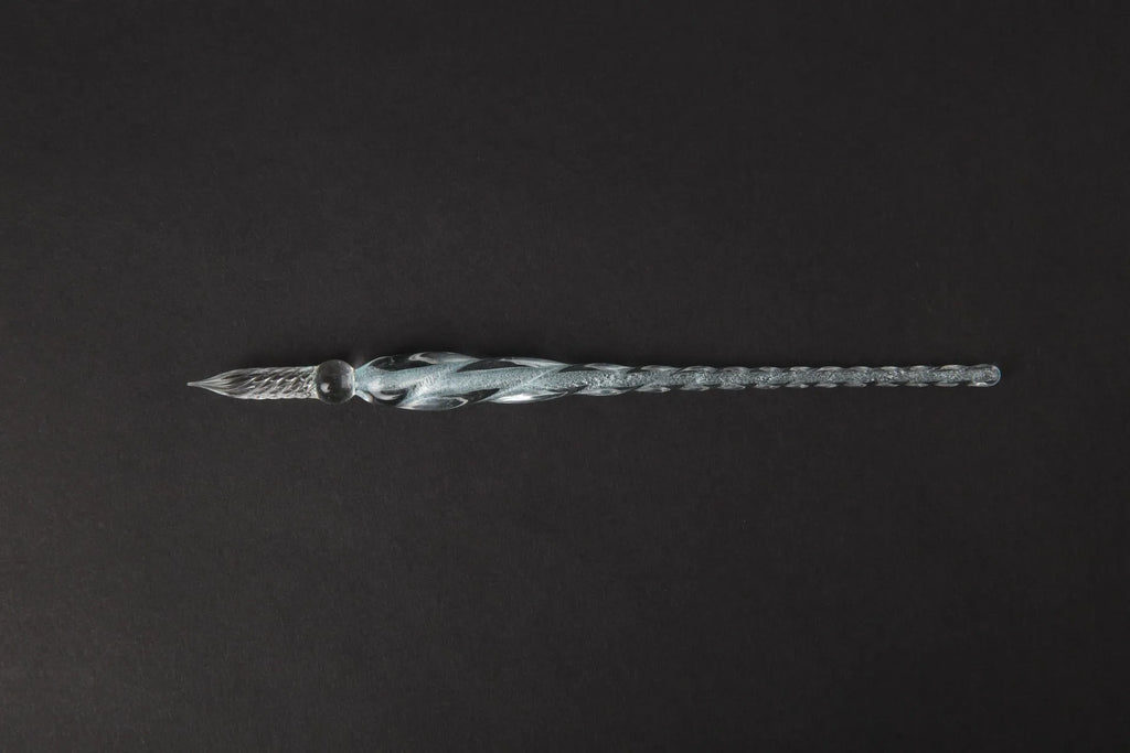 Transparent glass crystal pen with coloured ink visible inside, 0.5mm fine tip, simple modern design