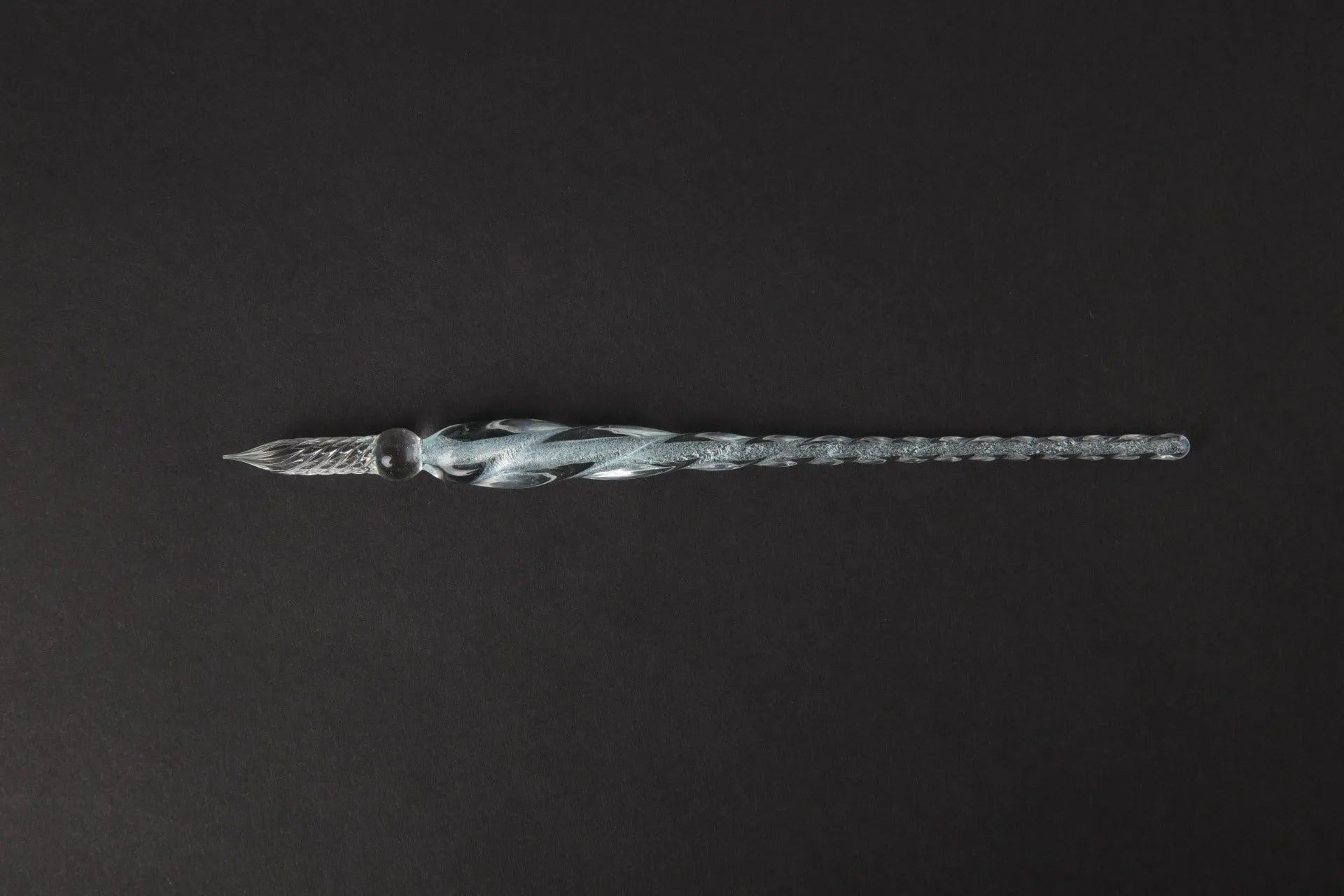Transparent glass crystal pen with coloured ink visible inside, 0.5mm fine tip, simple modern design