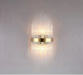 Modern crystal petal wall lamp with metallic gold finish mounted on a light-coloured wall.