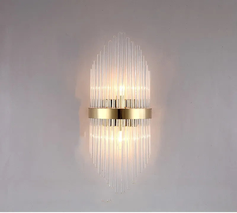 Modern crystal petal wall lamp with metallic gold finish mounted on a light-coloured wall.