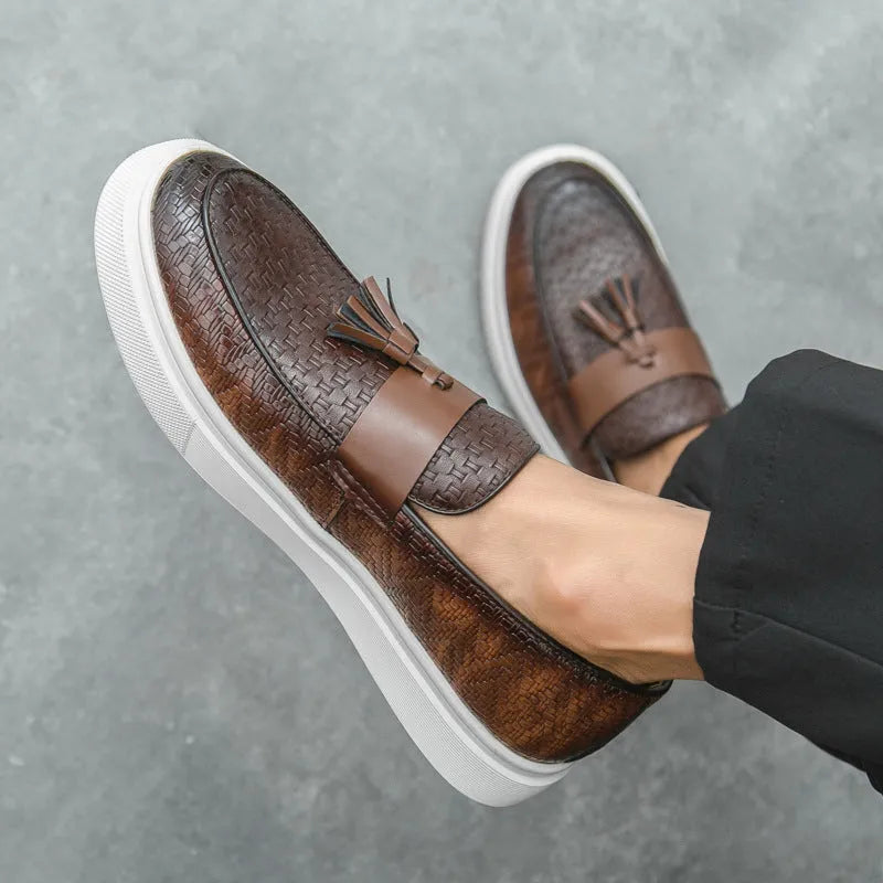 Men's black casual leather shoes with fringe detail on the upper and a low heel.