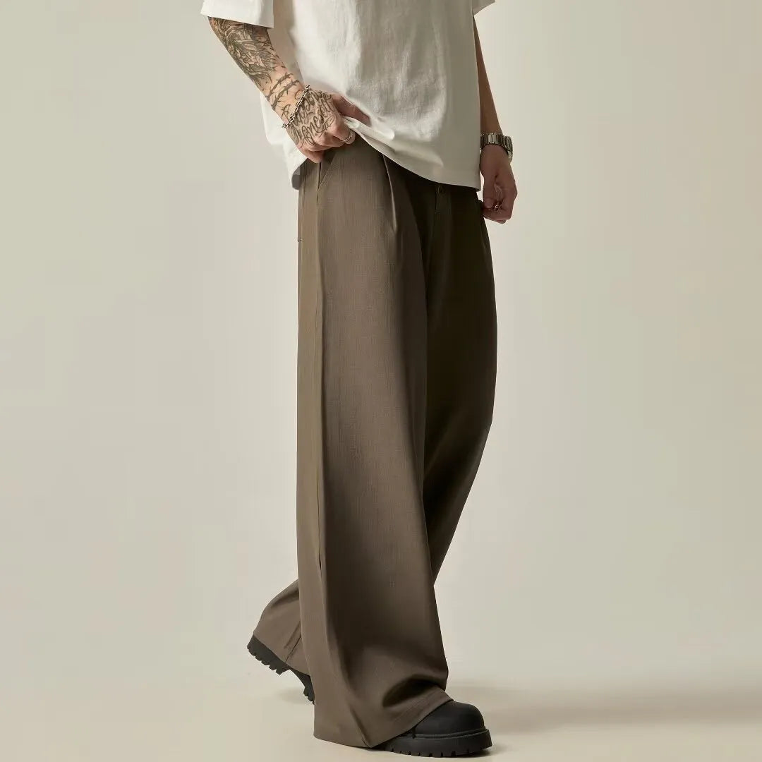Men's black casual trousers with elastic waistband and straight-leg design on hanger