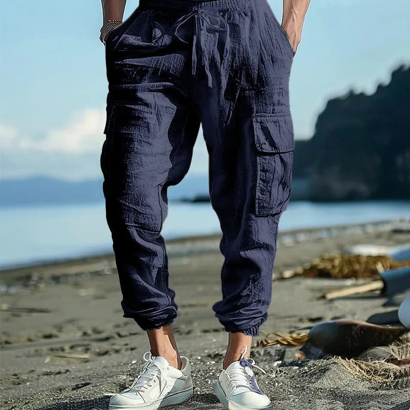 Men's loose-fit linen trousers with ankle ties and multiple pockets in solid colours