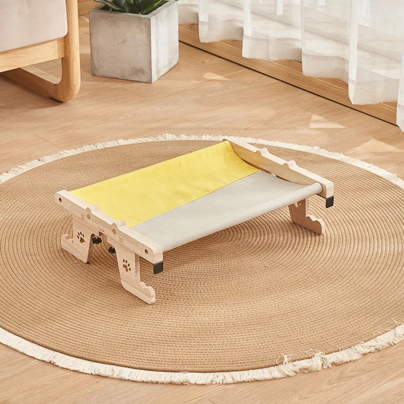 Wooden framed cat hammock bed hanging by a window, suitable for cats and small dogs.