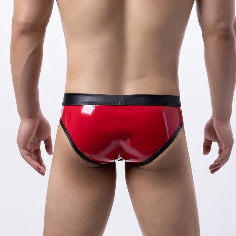 Man modelling gold patent leather look low-waist bikini swim briefs on beach