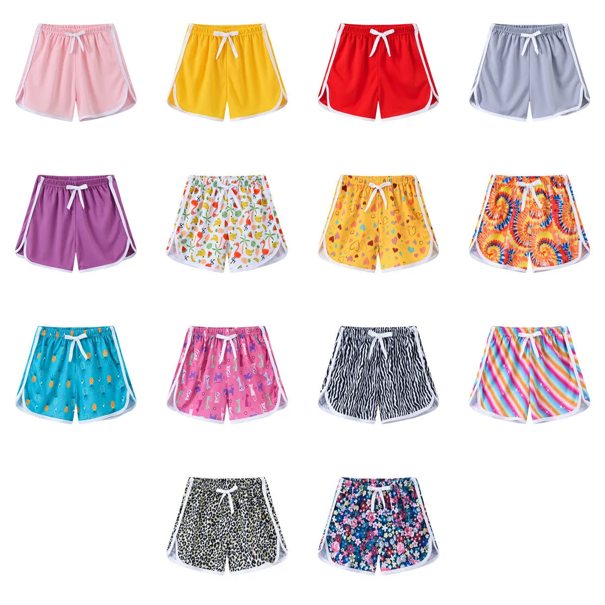 Children's beach shorts in multiple colours and patterns including pineapple print and solid colours