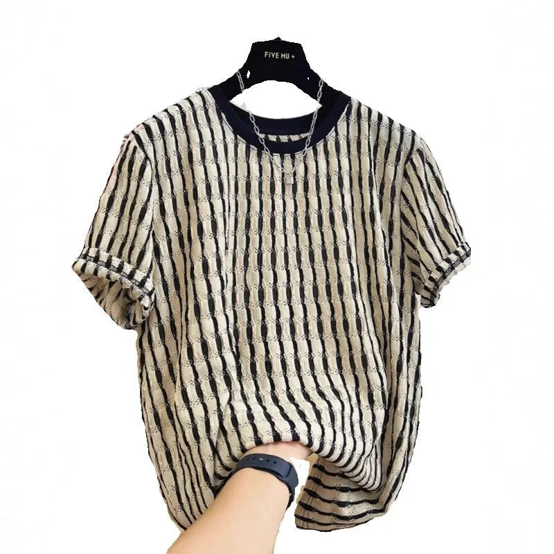 Men's black striped short-sleeve shirt with loose fit, made from linen and silk blend, shown in casual wear.