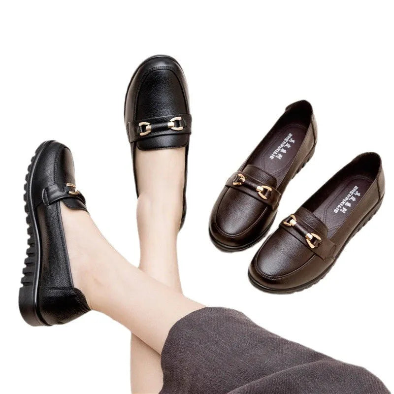 Black women's low-heel leather pumps with a round toe and soft rubber sole.