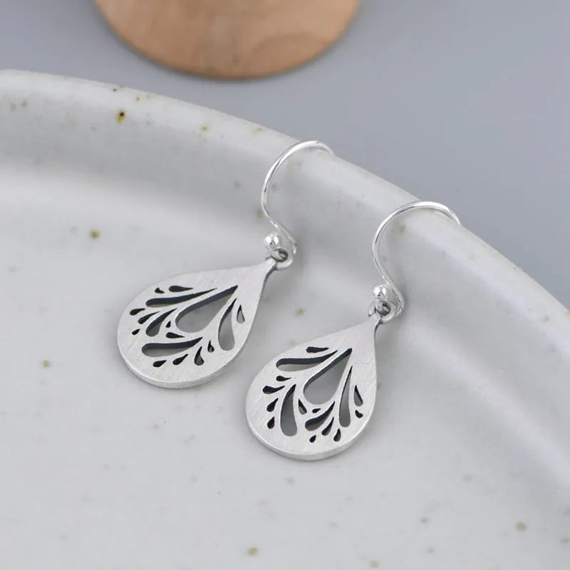 Pair of silver retro hollow water drop earrings with a hand-ground finish.