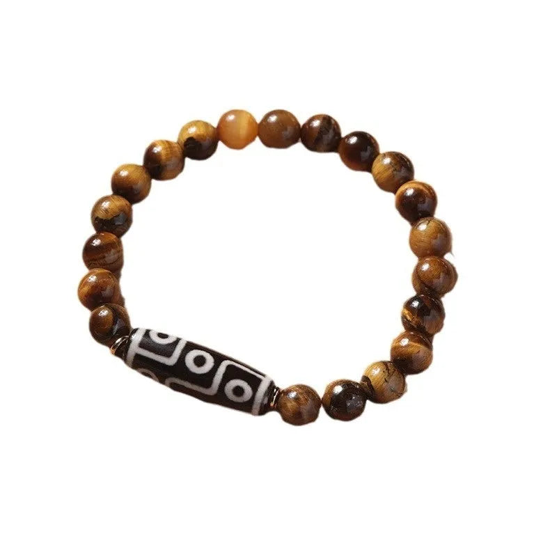 Close-up of a single circle tigereye stone Buddha rosary bracelet showing the chatoyant beads on a string.