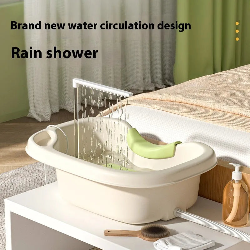 Portable bed shampoo basin with integrated neck pillow, circulating water pump, drain pipe, and massage brush for hair washing while lying down