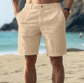 Men's solid colour cotton casual trousers with a button fly, shown in dark blue.
